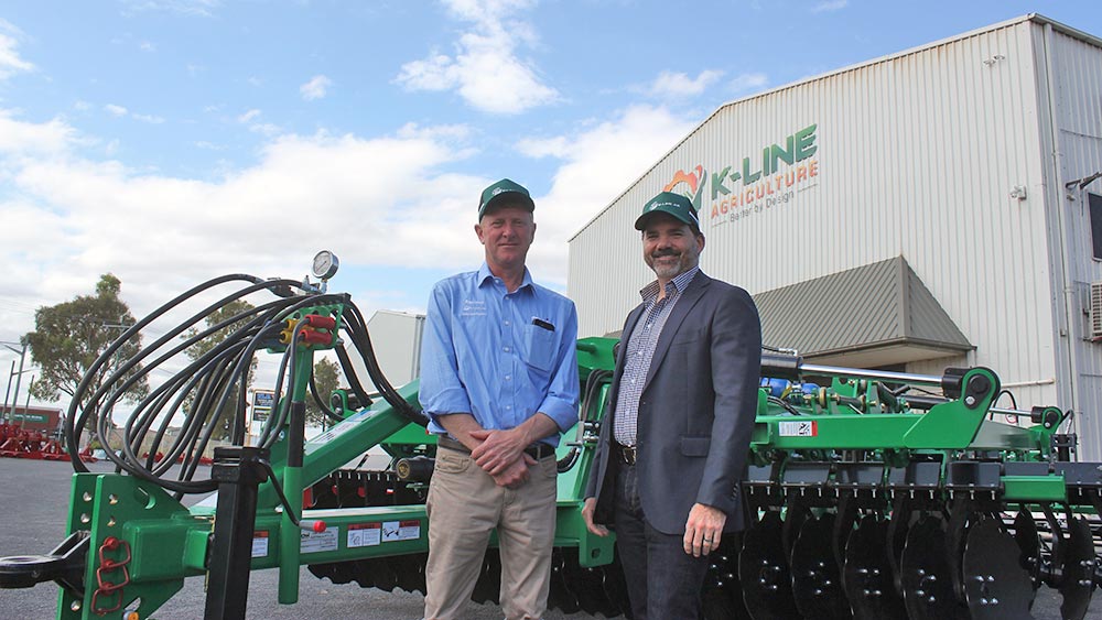 Bill Larsen, Sales & Marketing Manager K-Line Agriculture and Brandon Stannett, Managing Director, Agriculture, CNH Industrial ANZ, celebrate 30 years of K-Line Ag's innovation and success.